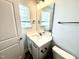Bathroom features a vanity with a white sink and a large mirror at 114 Southern Estates Dr, Sanford, NC 27330