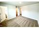 Spacious bedroom with neutral walls and carpet; a doorway leads to bathroom at 114 Southern Estates Dr, Sanford, NC 27330