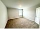 Spacious bedroom featuring neutral walls, plush carpet, and natural light from a window at 114 Southern Estates Dr, Sanford, NC 27330