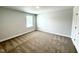 Neutral bedroom offers comfort with soft carpet and natural light from window at 114 Southern Estates Dr, Sanford, NC 27330