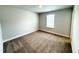 Neutral bedroom with plush carpet and a window providing natural light at 114 Southern Estates Dr, Sanford, NC 27330