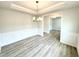 Elegant dining room with modern light fixture, wainscoting, and durable hardwood flooring at 114 Southern Estates Dr, Sanford, NC 27330