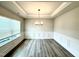 Elegant dining room features wainscoting, tray ceilings, modern light fixture, and large window at 114 Southern Estates Dr, Sanford, NC 27330