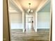 Inviting hallway with contemporary lighting, wainscoting, and durable hardwood flooring at 114 Southern Estates Dr, Sanford, NC 27330