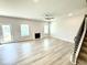 Open living room featuring a fireplace, hardwood floors, and natural light at 114 Southern Estates Dr, Sanford, NC 27330