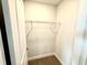 Small walk-in closet with wire shelving; neutral carpet and paint at 114 Southern Estates Dr, Sanford, NC 27330