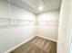 Spacious walk-in closet with wire shelving for ample storage; neutral carpet at 114 Southern Estates Dr, Sanford, NC 27330