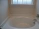 Clean bathroom with a bathtub and window at 1850 Gillburg Road, Henderson, NC 27537