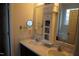 Double vanity bathroom with marble countertops, and a mirrored medicine cabinet at 1850 Gillburg Road, Henderson, NC 27537