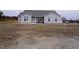 Ranch style home with gray siding, attached garage, and a spacious yard at 1850 Gillburg Road, Henderson, NC 27537