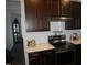 Modern kitchen with dark cabinets, stainless steel appliances, and white tile at 1850 Gillburg Road, Henderson, NC 27537