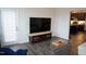 Living room with TV, coffee table, and kitchen view at 1850 Gillburg Road, Henderson, NC 27537