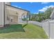 Backyard featuring a covered patio with a ceiling fan, a white privacy fence, and lush greenery, perfect for outdoor enjoyment at 9113 Dupree Meadow Dr # 41, Angier, NC 27501
