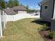 Fenced backyard with grass, landscaping, and views of neighboring houses at 9113 Dupree Meadow Dr # 41, Angier, NC 27501