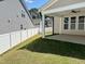 A home's backyard features a covered patio, white vinyl fence, and green grass at 9113 Dupree Meadow Dr # 41, Angier, NC 27501