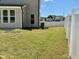 Grassy fenced backyard featuring neighboring homes, landscaping, and an air conditioning unit at 9113 Dupree Meadow Dr # 41, Angier, NC 27501