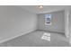 Well-lit bedroom with gray carpeting, neutral walls, and a window providing natural light at 9113 Dupree Meadow Dr # 41, Angier, NC 27501