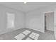 Spacious bedroom with neutral carpet, a ceiling light, and doors to a closet and the hallway at 9113 Dupree Meadow Dr # 41, Angier, NC 27501