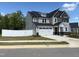 A two-story home with a two-car garage and a white fence surrounding the property at 9113 Dupree Meadow Dr # 41, Angier, NC 27501