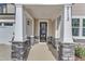 Inviting front entry with stone pillars and a black front door at 9113 Dupree Meadow Dr # 41, Angier, NC 27501