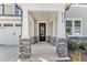 Welcoming front porch featuring stone-clad columns, a black front door with glass panes, and the house number at 9113 Dupree Meadow Dr # 41, Angier, NC 27501