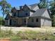 New construction home featuring a gray exterior, covered porch, dormer, and black framed windows at 133 Slocum Ct, Wendell, NC 27591
