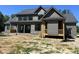 New construction home with a rear patio, covered porch, horizontal siding, and black framed windows at 133 Slocum Ct, Wendell, NC 27591