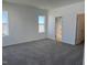 Spacious bedroom with carpet, white walls, and natural light from two windows at 32 Furley St., Homesite 53, Sanford, NC 27330