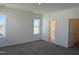 Spacious bedroom with carpet, white walls, and natural light from two windows at 32 Furley St., Homesite 53, Sanford, NC 27330