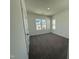 Bright bedroom with carpeted floors and neighborhood views at 32 Furley St., Homesite 53, Sanford, NC 27330
