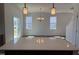 Open dining area featuring elegant lighting, laminate floors, and a sliding glass door at 32 Furley St., Homesite 53, Sanford, NC 27330