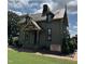 Two-story Railroad House Museum featuring a unique exterior, with a sign and brick walkway at 32 Furley St., Homesite 53, Sanford, NC 27330