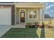 Inviting front porch with manicured lawn and garden adjacent to an attached garage at 32 Furley St., Homesite 53, Sanford, NC 27330