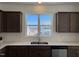 Modern kitchen sink with stainless steel appliances, mosaic backsplash, and natural light at 32 Furley St., Homesite 53, Sanford, NC 27330