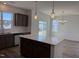 Open kitchen featuring granite counters, island, pendant lights, and stainless steel appliances at 32 Furley St., Homesite 53, Sanford, NC 27330
