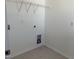 Laundry room with hookups, white walls and tile floor at 32 Furley St., Homesite 53, Sanford, NC 27330