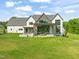 Expansive backyard featuring a modern home with a covered patio, and lush green lawn, perfect for outdoor living at 9009 Meadow Pointe Ct, Wake Forest, NC 27587