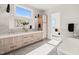 Elegant bathroom with dual sinks, a stylish soaking tub, and a view into the bedroom at 9009 Meadow Pointe Ct, Wake Forest, NC 27587
