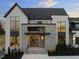 Inviting home exterior featuring a stone facade, grand windows, and a well-lit entrance that enhances the property's curb appeal at 9009 Meadow Pointe Ct, Wake Forest, NC 27587