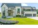 Stunning two-story home featuring modern design, stone accents, and a beautifully landscaped front yard at 9009 Meadow Pointe Ct, Wake Forest, NC 27587