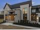 Modern home exterior with stone accents, multiple stories, lush landscaping, and contemporary design elements, perfect for luxurious living at 9009 Meadow Pointe Ct, Wake Forest, NC 27587