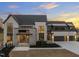 Stunning modern home boasts a brick and stone exterior, large windows, manicured landscaping, and a multi-car garage at 9009 Meadow Pointe Ct, Wake Forest, NC 27587