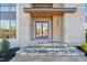 Modern front entry with stone facade and double doors at 9009 Meadow Pointe Ct, Wake Forest, NC 27587