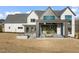 Modern farmhouse exterior with large patio and landscaped yard at 9009 Meadow Pointe Ct, Wake Forest, NC 27587