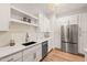 White kitchen with stainless steel appliances and quartz countertops at 9009 Meadow Pointe Ct, Wake Forest, NC 27587