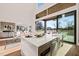 Island kitchen features white quartz countertops and stainless steel appliances at 9009 Meadow Pointe Ct, Wake Forest, NC 27587
