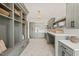 Laundry room with gray cabinets and built-in bench at 9009 Meadow Pointe Ct, Wake Forest, NC 27587