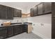 Laundry room with dark cabinetry and granite counters at 9009 Meadow Pointe Ct, Wake Forest, NC 27587