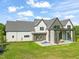 Stunning rear exterior view with a covered patio, stone accents, and a well-manicured lawn at 9009 Meadow Pointe Ct, Wake Forest, NC 27587