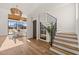 Modern staircase with glass and metal railing next to a wine cellar at 9009 Meadow Pointe Ct, Wake Forest, NC 27587